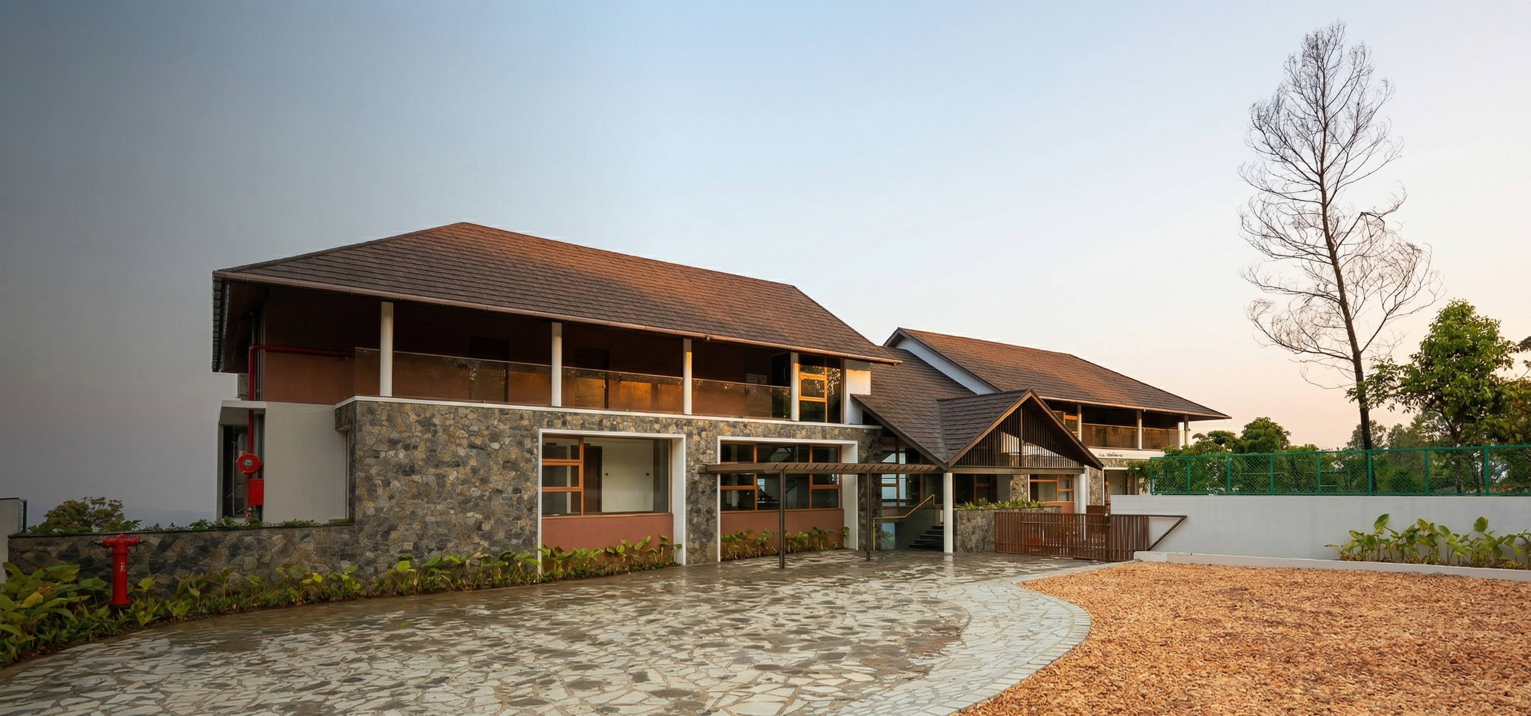 Olive Woods Munnar resort exterior with lush green hills